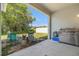Covered patio area with seating, a grill, and a view of the backyard and trees at 247 Winthrop Dr, Spring Hill, FL 34609