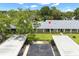 An overhead angle of the condo with carports and a well-maintained green lawn at 2557 Laurelwood Dr # 10D, Clearwater, FL 33763