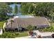 Aerial view of clubhouse near lake surrounded by lush trees and landscaping at 2557 Laurelwood Dr # 10D, Clearwater, FL 33763