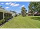 Beautifully maintained backyard with lush green grass, trees and ample room for recreation at 2557 Laurelwood Dr # 10D, Clearwater, FL 33763