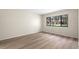 Bright, empty bedroom features a large window overlooking the outdoors and modern flooring at 2557 Laurelwood Dr # 10D, Clearwater, FL 33763