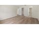 This bedroom has wood flooring and access to both the closet and bathroom at 2557 Laurelwood Dr # 10D, Clearwater, FL 33763