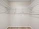 This walk-in closet has built-in metal shelving for optimal storage solutions at 2557 Laurelwood Dr # 10D, Clearwater, FL 33763
