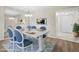 Cozy dining area with stylish blue chairs, with view into kitchen and entry way at 2557 Laurelwood Dr # 10D, Clearwater, FL 33763
