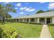 Charming condo exterior with well-manicured lawn and lush landscaping at 2557 Laurelwood Dr # 10D, Clearwater, FL 33763