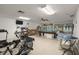 A spacious fitness room with exercise equipment, a pool table, and windows overlooks the outdoors at 2557 Laurelwood Dr # 10D, Clearwater, FL 33763