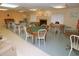 Well-lit game room with various tables, chairs, and a fireplace offers a relaxing social space at 2557 Laurelwood Dr # 10D, Clearwater, FL 33763