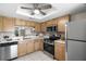 This kitchen features stainless steel appliances and a lovely backyard view at 2557 Laurelwood Dr # 10D, Clearwater, FL 33763