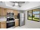 This kitchen has stainless steel appliances and a view of the outdoors at 2557 Laurelwood Dr # 10D, Clearwater, FL 33763