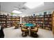A cozy library with floor-to-ceiling bookshelves, tables, and chairs provides a comfortable reading area at 2557 Laurelwood Dr # 10D, Clearwater, FL 33763