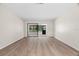 Spacious living room featuring wood floors and sliding glass doors to outdoors at 2557 Laurelwood Dr # 10D, Clearwater, FL 33763