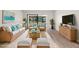 Bright and stylish living room with modern decor and sliding glass doors to outdoor space at 2557 Laurelwood Dr # 10D, Clearwater, FL 33763