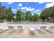 Inviting community pool surrounded by lounge chairs for relaxing by the water at 2557 Laurelwood Dr # 10D, Clearwater, FL 33763