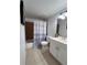 Cozy bathroom features a shower/tub combo and a white single sink vanity at 2850 Somerset Park Dr # 203, Tampa, FL 33613