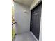 Front door of unit 203, next to a stucco wall, and protected by a small covered porch at 2850 Somerset Park Dr # 203, Tampa, FL 33613