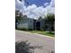 A two-story building featuring manicured landscaping, and a grey painted exterior, under a cloudy sky at 2850 Somerset Park Dr # 203, Tampa, FL 33613