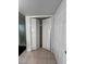 A hallway featuring a closet with bi-fold doors, and neutral tile floors at 2850 Somerset Park Dr # 203, Tampa, FL 33613