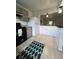 Open kitchen featuring grey cabinets, black appliances, and a view to the living space at 2850 Somerset Park Dr # 203, Tampa, FL 33613