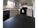 An updated kitchen with black appliances, grey cabinets, and light colored countertops at 2850 Somerset Park Dr # 203, Tampa, FL 33613