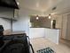 A well-lit kitchen with white cabinets, modern appliances, and an open layout design at 2850 Somerset Park Dr # 203, Tampa, FL 33613