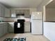 A kitchen featuring grey cabinets, black appliances, and an updated refrigerator at 2850 Somerset Park Dr # 203, Tampa, FL 33613