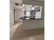 Kitchen featuring tan floors, a breakfast bar, updated appliances, and gray colored cabinets at 2850 Somerset Park Dr # 203, Tampa, FL 33613