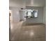 Open-concept living space showcasing tile floors, kitchen view, and natural light at 2850 Somerset Park Dr # 203, Tampa, FL 33613