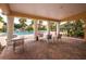 A relaxing poolside patio and shaded seating area are perfect for unwinding in the community at 2850 Somerset Park Dr # 203, Tampa, FL 33613