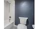 Bathroom featuring a white tiled tub/shower combination, gray walls, and toilet at 2901 W 26Th St # 301, Bradenton, FL 34205