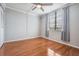 Bright bedroom featuring a ceiling fan, wood-look flooring, and natural light from the window at 2901 W 26Th St # 301, Bradenton, FL 34205