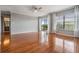Spacious bedroom featuring beautiful wood floors, a ceiling fan and a balcony view at 2901 W 26Th St # 301, Bradenton, FL 34205