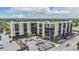 Exterior view of a mid-rise condo with parking and palm trees on a sunny day at 2901 W 26Th St # 301, Bradenton, FL 34205