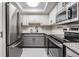Modern kitchen with stainless steel appliances, granite countertops, and white upper cabinets at 2901 W 26Th St # 301, Bradenton, FL 34205
