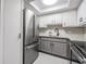 Clean kitchen featuring stainless steel appliances, white cabinets, and granite countertops at 2901 W 26Th St # 301, Bradenton, FL 34205