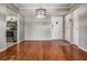 Bright living room featuring sleek hardwood floors and an elegant pendant lighting fixture at 2901 W 26Th St # 301, Bradenton, FL 34205