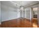 Inviting living area with wood-look flooring, ceiling fan, adjacent to bathroom and front door at 2901 W 26Th St # 301, Bradenton, FL 34205