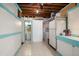 Unfinished basement with washer/dryer hookups, extra storage, and a bathroom at 301 Cevera Dr, Dunedin, FL 34698