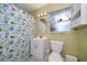 Cozy bathroom with a shower, a single sink vanity, and ample lighting at 301 Cevera Dr, Dunedin, FL 34698