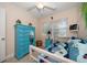 Bright bedroom boasts a ceiling fan, colorful decor, and lots of natural light at 301 Cevera Dr, Dunedin, FL 34698