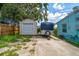 Spacious driveway with a shed and trailer, providing ample parking at 301 Cevera Dr, Dunedin, FL 34698