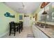 Bright kitchen features granite counters, tile flooring and an adjacent dining area at 301 Cevera Dr, Dunedin, FL 34698