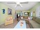 Bright living room showcasing comfortable furniture, terrazzo flooring, and charming coastal accents at 301 Cevera Dr, Dunedin, FL 34698