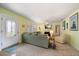 Cozy living room with a comfortable green sofa, terrazzo floors, and coastal-themed decor at 301 Cevera Dr, Dunedin, FL 34698