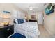 Spacious bedroom featuring a ceiling fan, shuttered windows, and a TV at 301 Cevera Dr, Dunedin, FL 34698