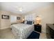 Comfortable bedroom boasts plantation shutters, ceiling fan, and beach-themed decor at 301 Cevera Dr, Dunedin, FL 34698