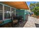 Outdoor dining area with covered awning on tiled patio at 301 Cevera Dr, Dunedin, FL 34698