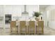 Modern kitchen with white cabinets, stainless steel appliances, and an island with seating for four at 31616 Cardinal Yard Dr, San Antonio, FL 33576