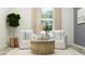 Relaxing sitting area featuring armchairs, decorative pillows, and a stylish coffee table at 31616 Cardinal Yard Dr, San Antonio, FL 33576
