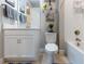 Bathroom featuring white fixtures, a shower-tub combo, toilet, and a vanity with decor at 3312 Francoa Dr, Odessa, FL 33556