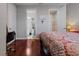 Bedroom with hardwood floors, walk-in closet, and adjacent bathroom at 3312 Francoa Dr, Odessa, FL 33556